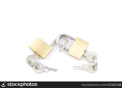 two golden padlocks and keys on white background