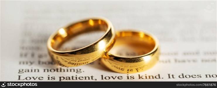 Two golden wedding rings on Holy bible book close up. Golden wedding rings on bible book