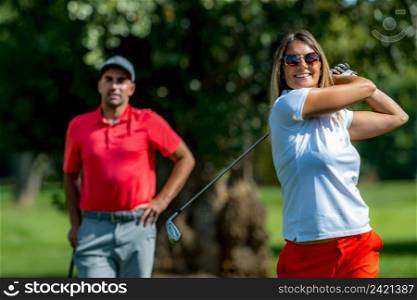 Two golfers, female and male playing golf 