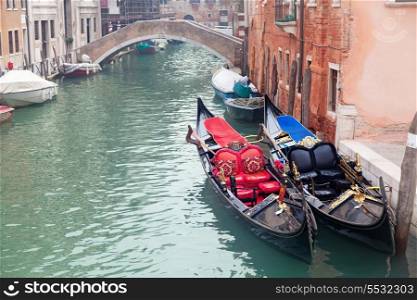 Two gondola in Venice near pier and golden figurines&#xA;