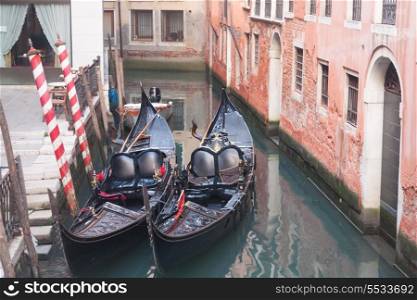 Two gondola in Venice near pier in channel&#xA;