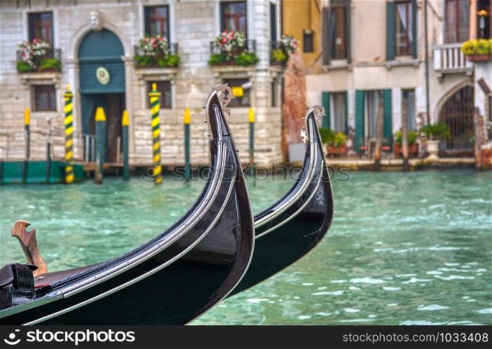 Two gondolas moored to the pier at the Grand Canal in Venice, Italy.