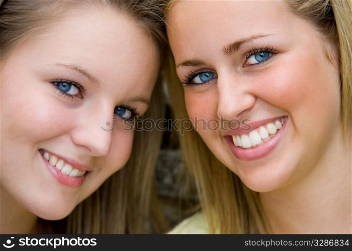 Two gorgeous young blond women shot in close up.