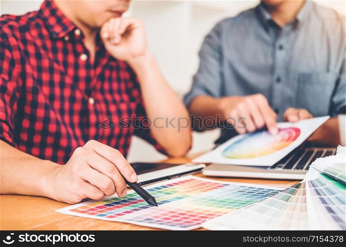 Two Graphic designer Brainstorming Meeting and drawing on graphics tablet at workplace