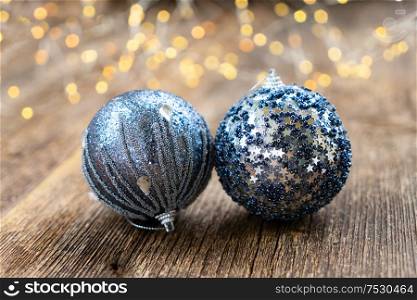 Two gray christmas balls on natural wood background. Elegant gray christmas