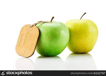 two green apple with tag isolated on white background