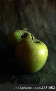 Two green apples isolated on painted background
