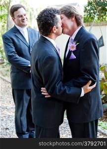 Two grooms kiss eachother in front of the minister at their gay marriage ceremony.&#xA;