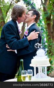 Two grooms kissing each other at their wedding reception.