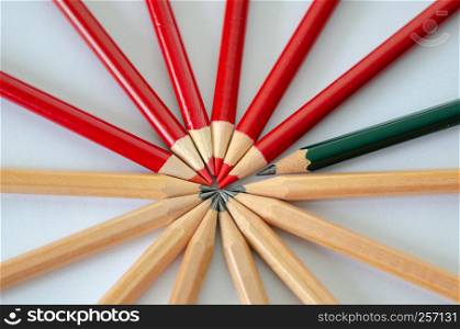 Two group of pencil and a green pencil. Leadership, uniqueness, independence, initiative, strategy, dissent, think different, business success concept