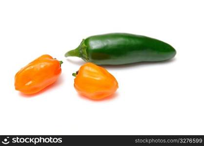 Two habanero chilies and a single jalapeno pepper isolated on a white background. Habanero and Jalapeno Chilies