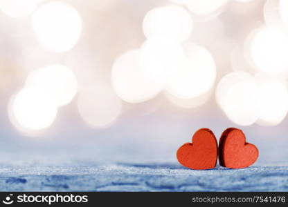 Two handmade wooden hearts on beautiful golden bokeh background. Vintage style. Love Valentine&rsquo;s Day concept.. Two hearts on bokeh background