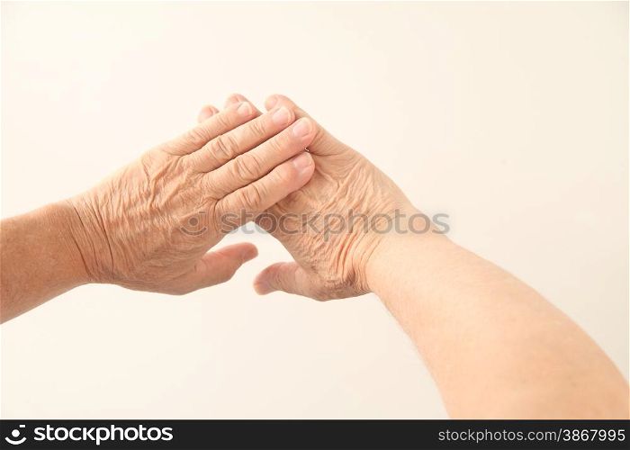 two hands belonging to a senior man