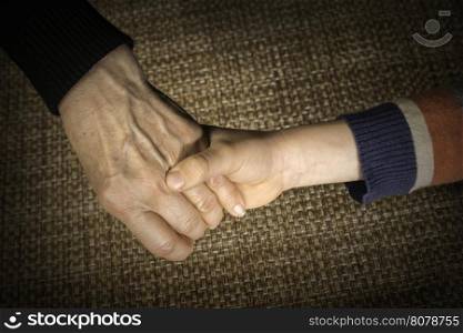 Two hands caught. Adult and child hand