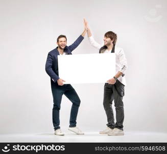 Two handsome guys giving each other a high-five