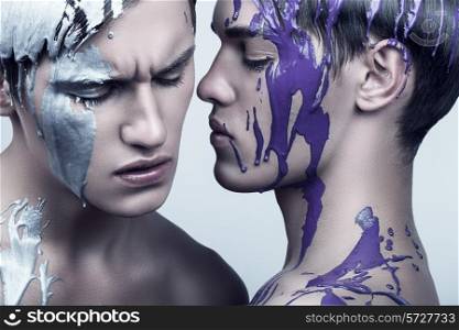 two handsome men in violet and silver paint