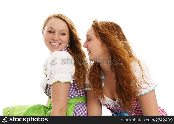 two happy bavarian dressed women looking at each other. two happy bavarian dressed women looking at each other on white background