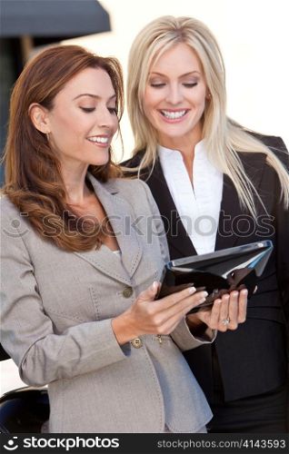 Two Happy Businesswomen Using a Tablet Computer