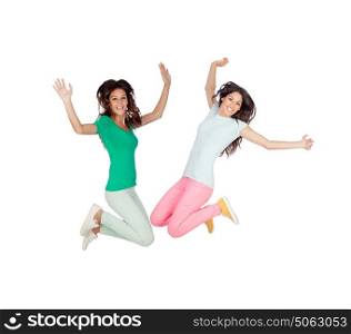 Two happy excited young women jumping over white background