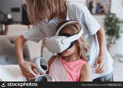 Two happy kids with pleasure playing video games. Advanced children study modern virtual reality technologies. Active childhood.. Brother and Sister Playing Video Game