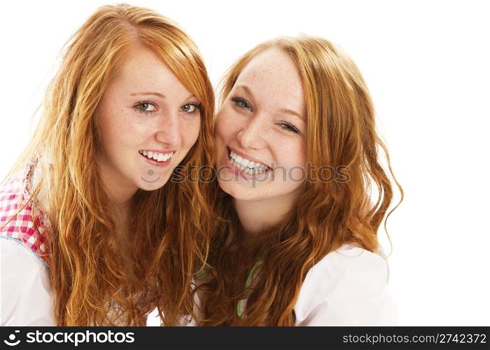 two happy redhead bavarian dressed girls. two happy redhead bavarian dressed girls on white background