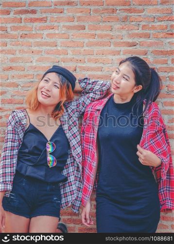 Two happy woman friends laughing with happiness. College students lifestyle.