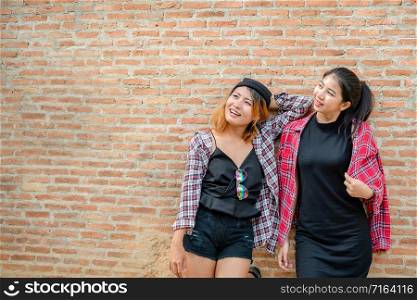 Two happy woman friends laughing with happiness. College students lifestyle.