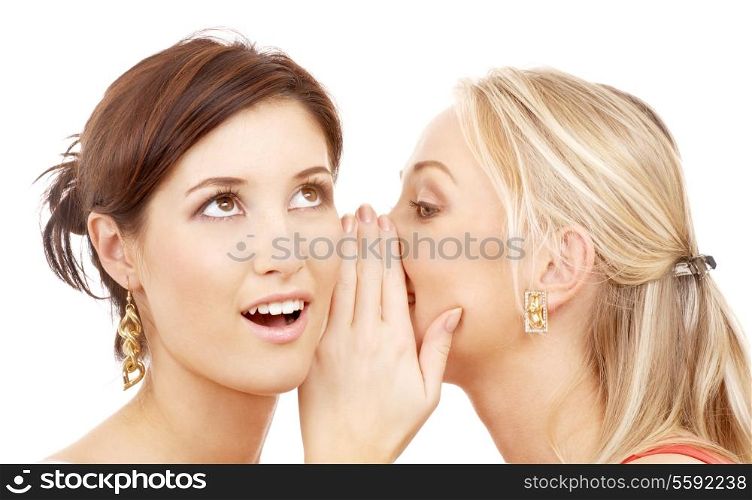 two happy young girlfriends talking over white