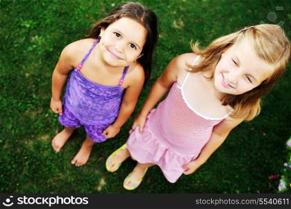 two happy young girls children have fun outdoor in nature