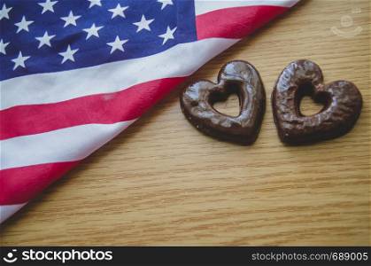 two heart shaped biscuits and usa flag on wooden table - happy memorial day.. two heart shaped biscuits and usa flag on wooden table happy memorial day.