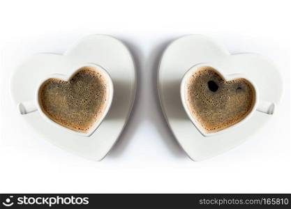 Two heart shaped cups of black coffee on white table. Love, Valentines Day concepts. Top view