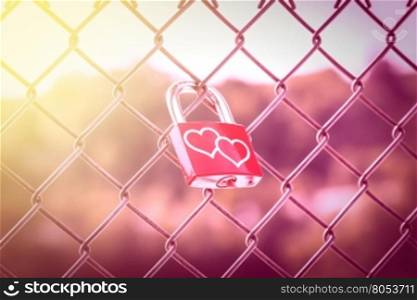Two hearts on Love Lockers on the fence with pink tone and soft light style