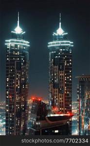 Two High Skyscrapers Glowing With Night Lights. Beautiful Modern Architecture. Luxury Lifestyle. Dubai. United Arab Emirates.