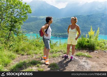Two hiker women talking near of Lake of Annecy