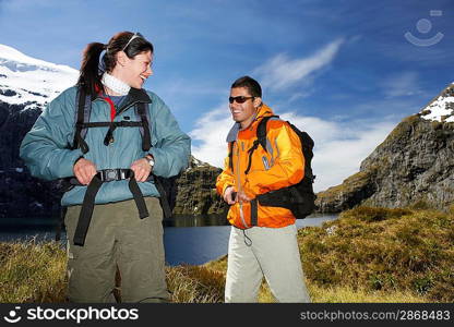 Two hikers smiling on mountain peak