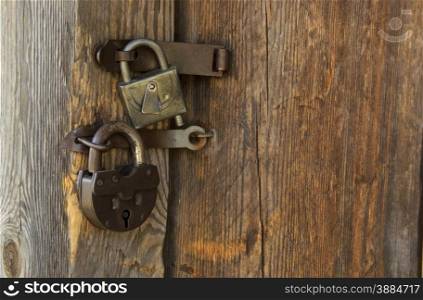 Two hinged iron lock on brown wooden door