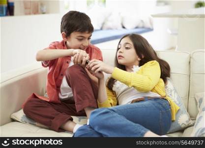 Two Hispanic Children Arguing Over TV Remote Control