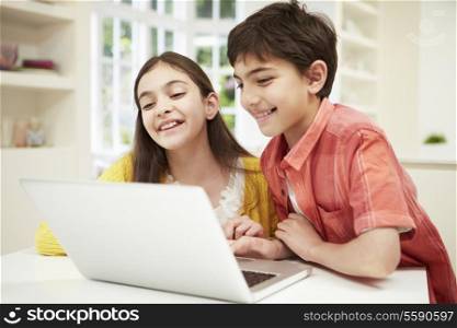 Two Hispanic Children Looking at Laptop