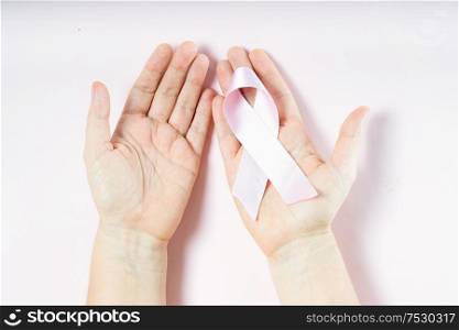 Two holding pink ribbon, symbol of breast cancer awareness. Pink ribbon, symbol of breast cancer awareness