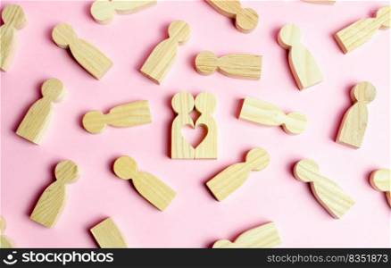 Two human figures together form a void in the shape of a heart on a pink background. Concept of love and search for the second half. Find a soul mate and start a family. Love and romance