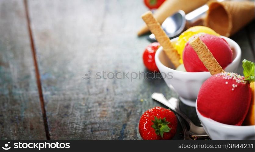 Two Ice cream scoops in bowls with wafer on wooden vintage background