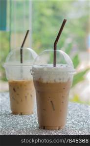 two Iced coffee with straw in plastic cup for take aways. Iced coffee with straw