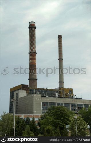 Two industrial chimneys. Vertical image