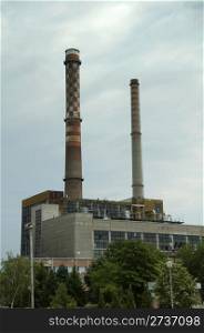 Two industrial chimneys. Vertical image