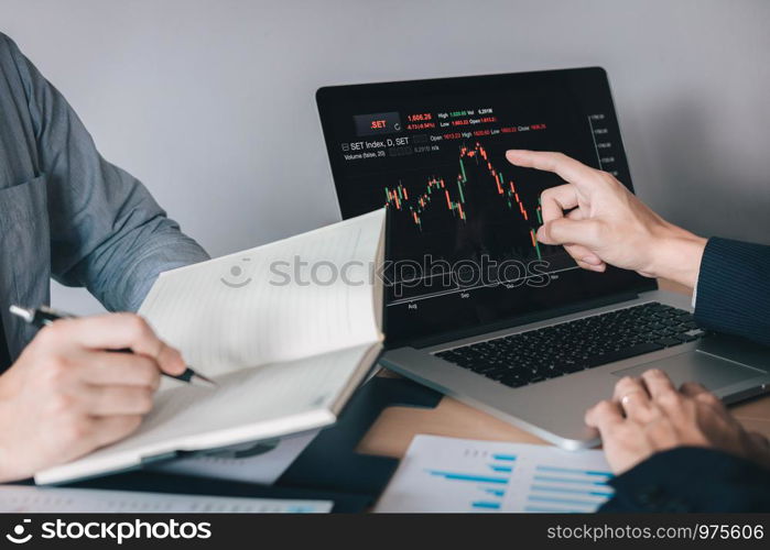 Two investors work together and note the stock price to compare with other stocks.