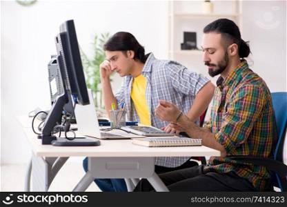 Two it specialists working in the office 