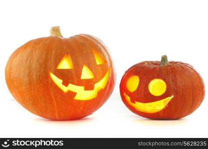 Two Jack O Lantern halloween pumpkins with candle light inside isolated on white background