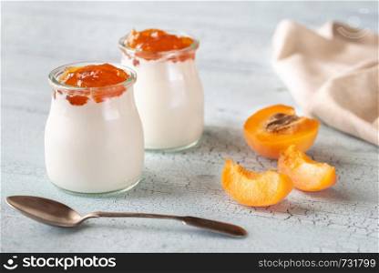 Two jars of Greek yogurt with apricot close-up