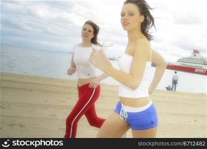 Two joggers on beach