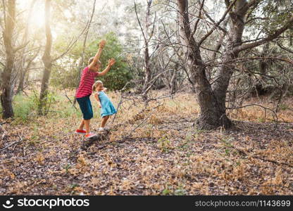 Two kids playing in the forest